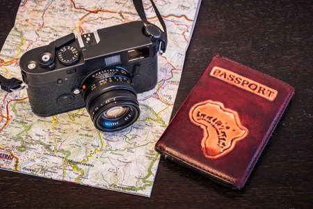 Travel Photography Concept - Photo Camera, Passport and Map on a Dark Wood Background - Vintage Lookの写真素材