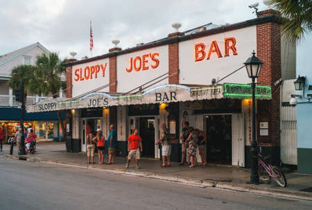Key West, Florida, United States - July 12 2012: Sloppy Joes Bar in the Evening with Illuminated Sign and Crowds of Tourists. A Famous Bar in Key West, FL, frequented by Ernest Hemingway.のeditorial素材