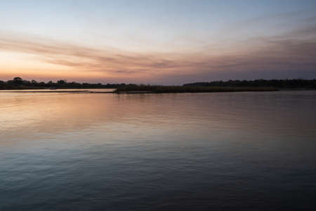Serene, Tranquil Okavango River Landscape near Divundu at Dusk in the Evening, Serenity or Tranquility Conceptの写真素材