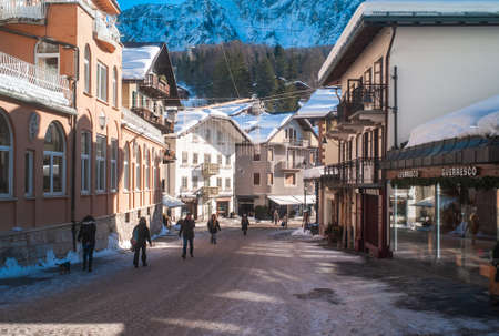 Cortina d Ampezzo, Italy - February 9 2019: Corso Italia Pedestrian Zone and Main Street in the Center of Cortina d Ampezzo, a Famous Skiing Resort in the Dolomites of Northern Italy on a Cold Winter Morning with Snow.のeditorial素材