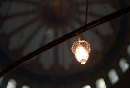 Lightbulb and old Lamp Lighting the Interior of an Islamic Mosque, Concept for Religion of Islam...