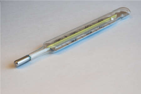 Clinical Fever Thermometer on White Background, a Concept for Illness, Fever, Corona Virus Covid-19...