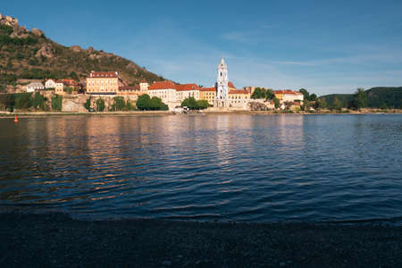 Duernstein Cityscape with Blue and White Baroque Abbey Church Tower, located on the River Danube in Wachau Valley, Austria in the Eveningの写真素材