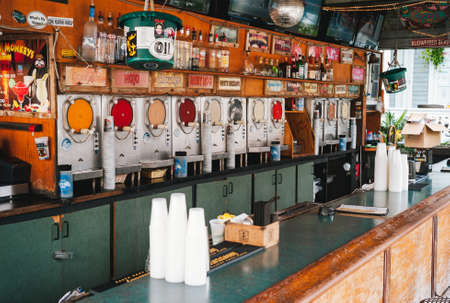 Key West, Florida, United States - July 11 2012: Bar Counter with Slush Machines in Flying Monkeys Saloon, a Tropical Open Air Bar in the Florida Keys serving Frozen Cocktails.のeditorial素材