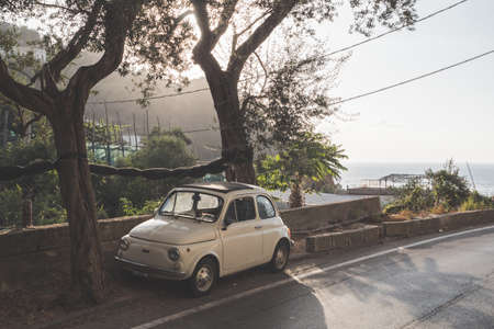 Massa Lubrense, Italy - August 23 2020: Retro, Vintage Fiat Nuova 500 Cinquecento Car in Beige or Ivory parked on the Sorrentine Coast in Summerのeditorial素材