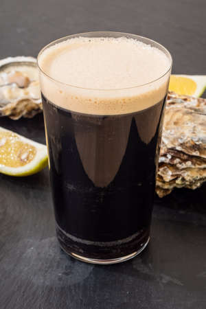 Raw Oyster and Stout with a Lemon Wedge, an Irish Cuisine Specialityの写真素材