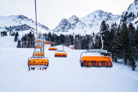 Haus im Ennstal, Austria - December 29 2020: Alm 6er 6 Seater Chair Lift going up the Mountain in...