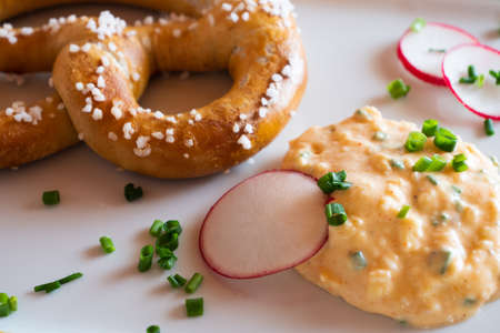 Obatzda, a Bavarian Cheese Spread also called Obatzter or Obazda with a Pretzel called Brezel or...