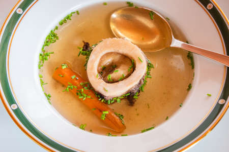 Beef Bouillon Soup with Marrow Bone, Carrot and Chives, an Austrian Styleの写真素材