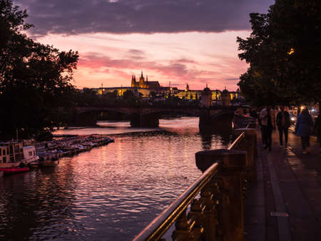 River Vltava in Prague at Sunset with Saint Vitus Cathedral and Romantic Evening Twilightの写真素材