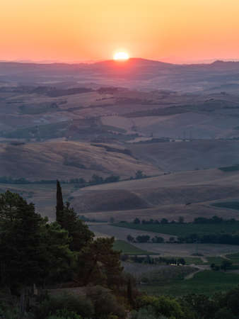 Sunrise in the Hills of Montalcino, Tuscany, in the Crete Senesi Region, Vertical Orientationの写真素材