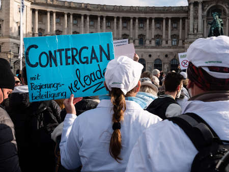 Vienna, Austria - November 20 2021: Anti-Vaccination Protester at Demonstration on Heldenplatz in Vienna, hold ing Sign 'Contergan Reloaded'.のeditorial素材