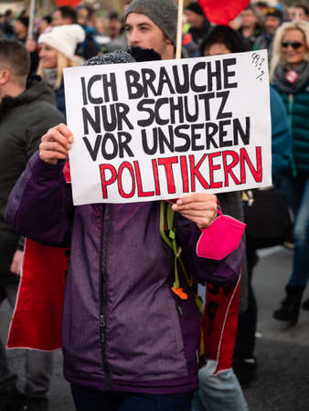 Vienna, Austria - November 20 2021: Anti-Vax Covid-19 Demonstrator Holding Sign 'I only need protection from our politicians'.のeditorial素材
