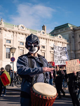 Vienna, Austria - November 20 2021: Masked Anti-Vax Covid-19 Demonstrator Drumming on Heldenplatzのeditorial素材