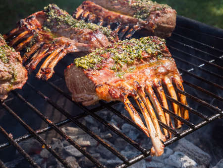 Racks of Lamb on the BBQ Grill Grate Browned with Herbsの写真素材