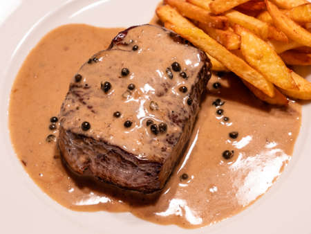 Tenderloin Steak with Green Peppercorn Sauce or Filet Mignon and Sauce Pouvre Vertの写真素材