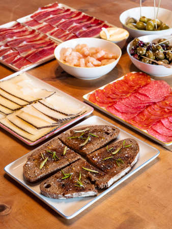 Mixed Spanish Tapas on a Table with Pa amb oli Bread with Oil, Manchego Cheese and Chorizo