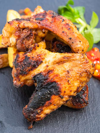 Grilled Hot Chicken Wings with Potato Wedges, a Spicy Dip and Field Saladの写真素材