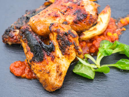 Grilled Hot Chicken Wings with Potato Wedges, a Spicy Dip and Field Saladの写真素材