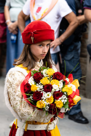 Flower Girl of the Valdimontone Contrada at the Cero Votivo Procession at the Palio di Siena in Tuscany, Italyのeditorial素材