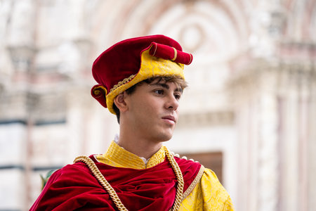 Siena, Tuscany, Italy - August 15 2022: Istrice or Porcupine Contrada Member in Renaissance Historical Costume at the Palio di Sienaのeditorial素材