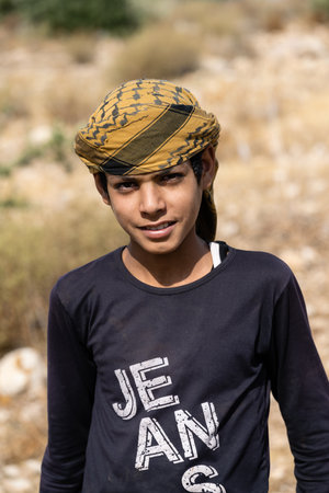 Mount Nebo, Madaba, Jordan - October 26 2022: Jordanian Shepherd Boy Wearing a Traditional Keffiyeh Headscarfのeditorial素材