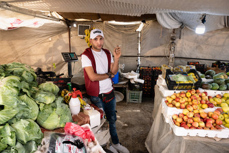 Dayr Allah, Jordan - October 25 2022: Fruit and Vegetable Vendor Selling Groceries in Market Stalls.のeditorial素材