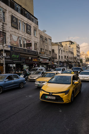 Amman, Jordan - October 26 2022: Yellow Taxi Cab and Traffic on the Al Hashemi Street in Amman City.のeditorial素材
