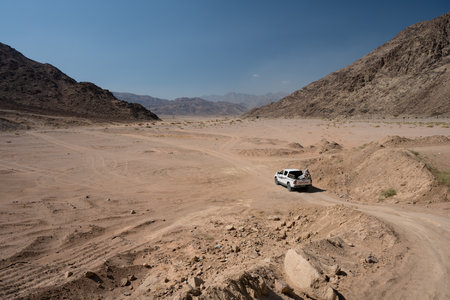 Wadi Rum, jordan - October 30 2022: Toyota Hilux Pickup Truck Driving through Wadi Rum Desert Valley in Jordanのeditorial素材