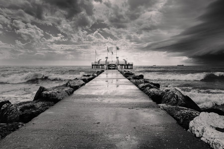 Lido di Venezia, Venice, Italy - August 19 2023: Incoming Storm, Jetty and Platform on the Beach at the Lido di Venezia in Venice.のeditorial素材