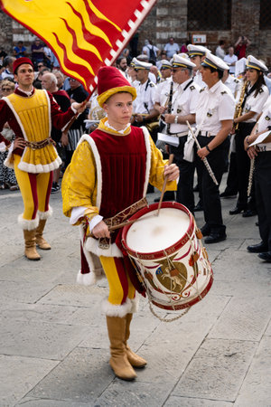 Siena, Italy - August 14 2022: Valdimontone Contrada Drummer and Flag Bearer at the Procession of the Candles and Censors before the Palio.のeditorial素材