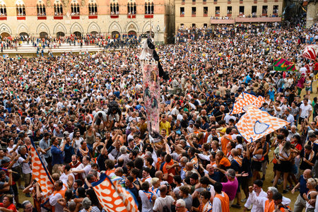 Siena, Italy - August 17 2022: Palio di Siena Victory Celebration on the Piazza del Campo with Drappellone and Flags of the Leocorno Contrada.のeditorial素材