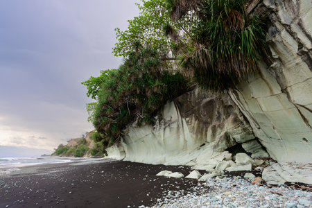 Penggajava Beach with Black Sand and Green Pebbles on Flores Island, Indonesia