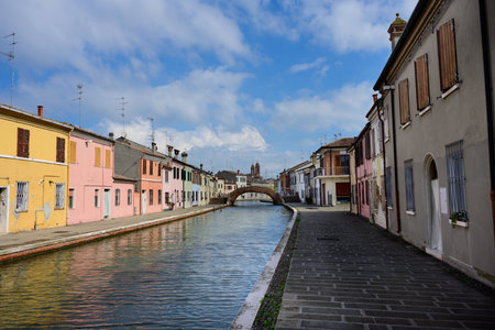 Comacchio, Italy - September 28 2025: Cityscape with Pastel Clored Houses of an old Fishing Village with Canalのeditorial素材
