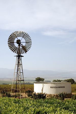 Windpump and reservoir situated on a wine farmの写真素材