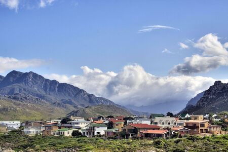 Storm approaching a village over a mountain rangeの写真素材