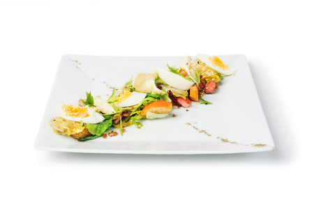 White plate of a fresh salad isolated on white backgroundの写真素材