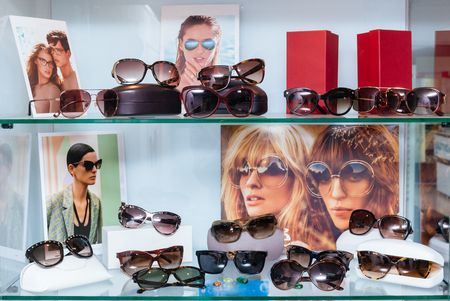 Modern fashion sun glasses on a shelfの写真素材