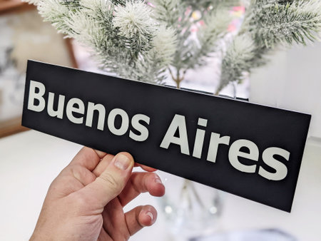 Man's hand holding a Buenos Aires signの写真素材