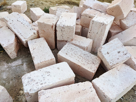 Building blocks of shell bricks construction material scattered at the construction site.の写真素材