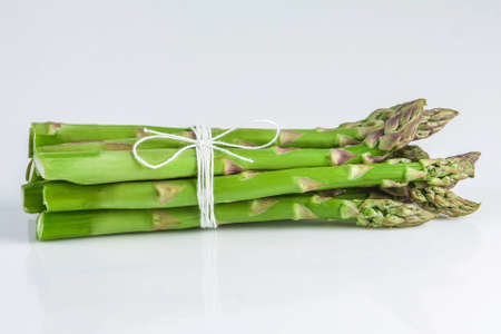 Sheaf of asparagus on a white background isolatedの写真素材