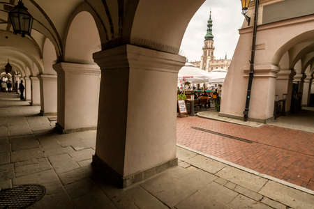 ZAMOSC, POLAND - August 31, 2013: Zamosc - Renaissance city in Central Europe. Arcades in old town city centre.のeditorial素材