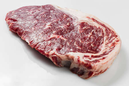 Ripened seasoned beef rump or striploin steak on white background isolatedの写真素材