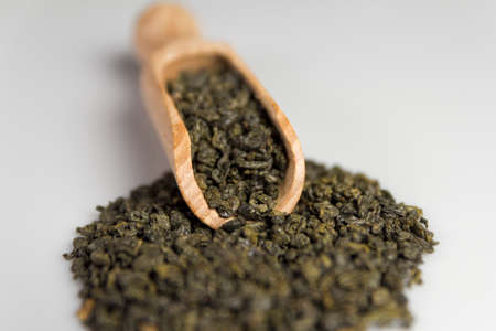 Gunpowder green tea in scoop isolated on a white background. Selective focus.の写真素材