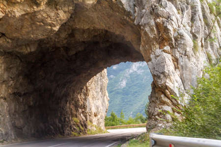 Tunnel on the road by Piva river canyon in the northern Montenegro.の写真素材
