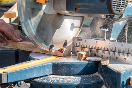 Roof construction building. Work on circular saw. Sawing wooden elements.の写真素材
