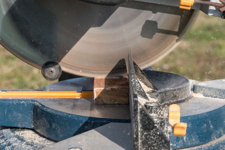 Roof construction building. Work on circular saw. Sawing wooden elements.の写真素材