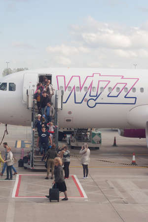 Luton/England - October 11, 2018: Passengers leaving Wizzair airplane after flight to Luton airport.のeditorial素材