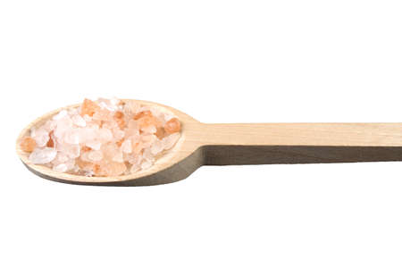 Himalayan pink salt  in wooden spoon isolated on white background. Closeup.の写真素材