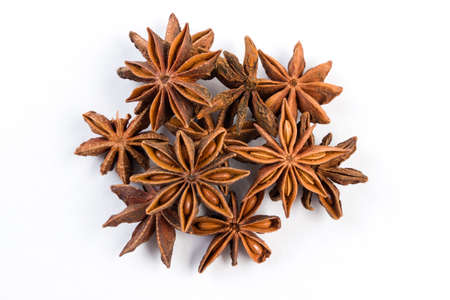 heap of anise stars isolated on white background.  top view
